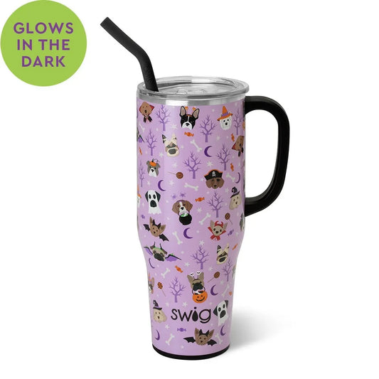 A 40oz stainless steel mug with a purple base and a pattern of various cartoon dogs and Halloween-themed elements, such as pumpkins and moons, glowing in the dark.